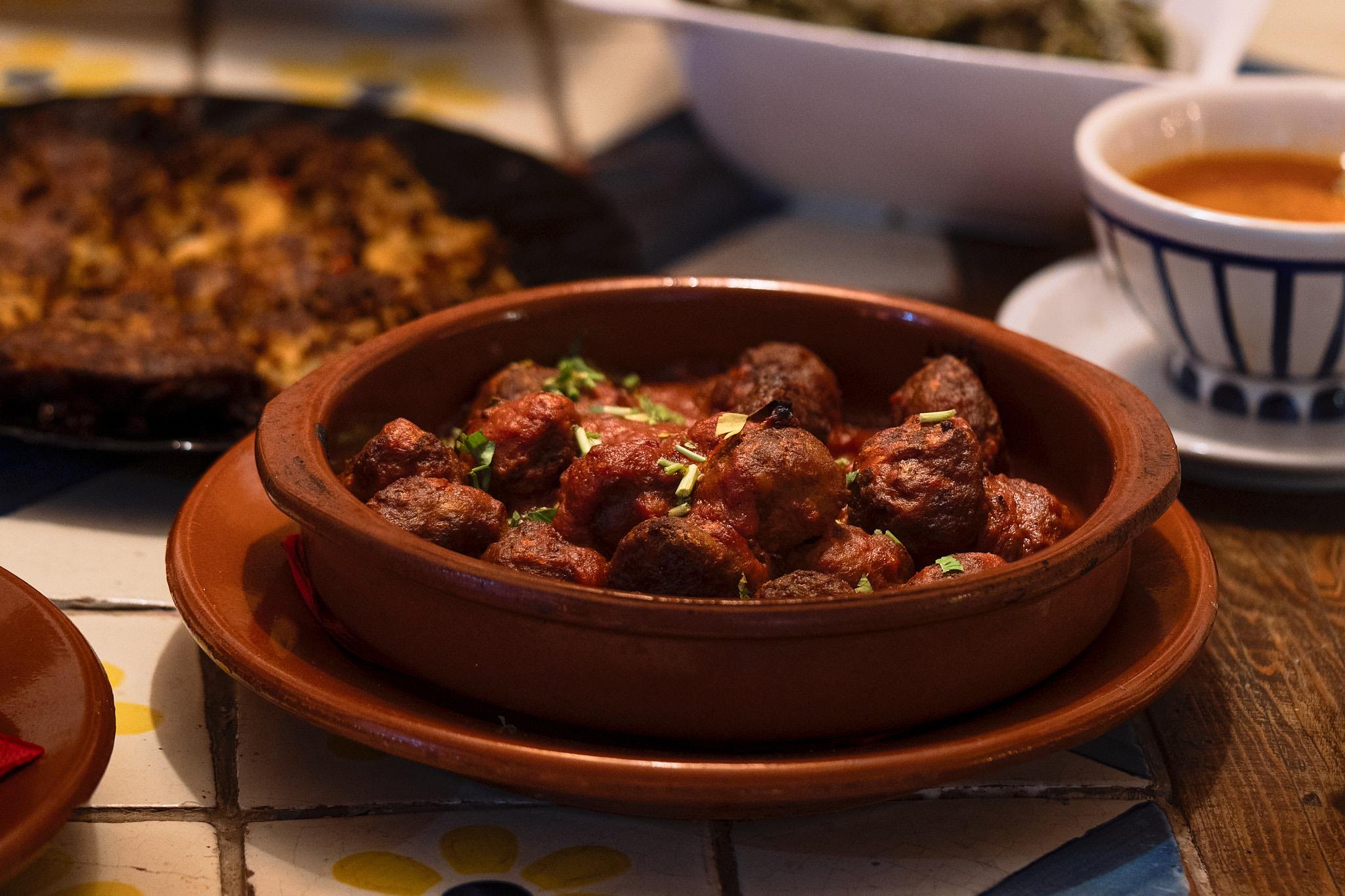 Meatballs in tomato sauce served in a terracotta dish