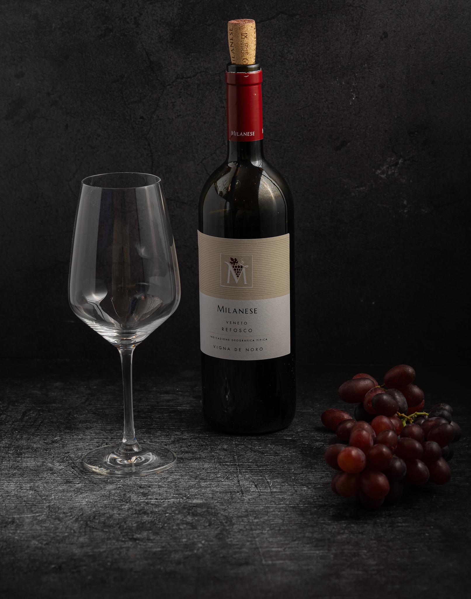 Refosco wine bottle with glass and grapes